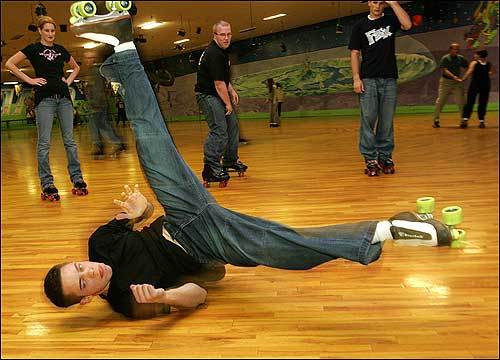 Man jam skating doing a break dancing windmill on skates